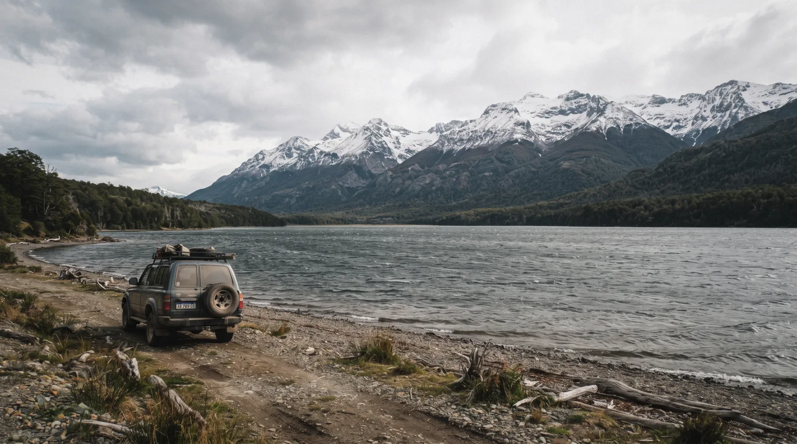 Off-road vehicle on a gravel track above Lake Fagnano on one of the classic day trips from Ushuaia, Tierra del Fuego, Argentina